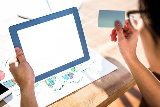 A person's hand typing on a laptop with a credit card visible, surrounded by charts and graphs, symbolizing strategic financial planning.