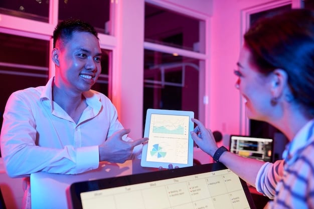 A diverse group of small business owners in a modern co-working space, discussing finances, with a tablet displaying a financial dashboard in the foreground.