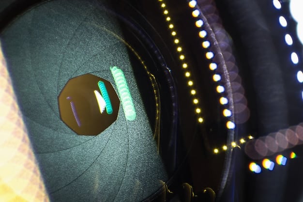 A close-up of a projector lens showcasing intricate optical technology. The lens reflects light, highlighting its precision and high-quality build within a home theater setting.