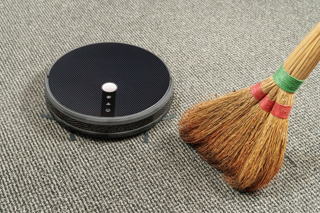 Close-up shot of a vacuum cleaner head with a soft brush roll, highlighting the texture and material of the bristles. The background should show a clean hardwood floor.