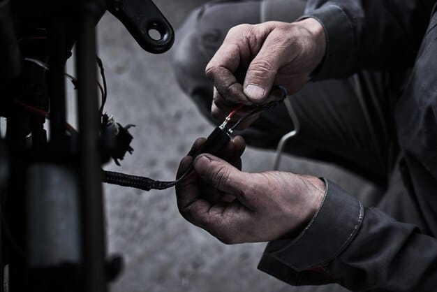A person performing maintenance on an e-bike, cleaning the chain and lubricating the gears. The setting is a clean, well-organized garage with various tools and bike accessories in the background.