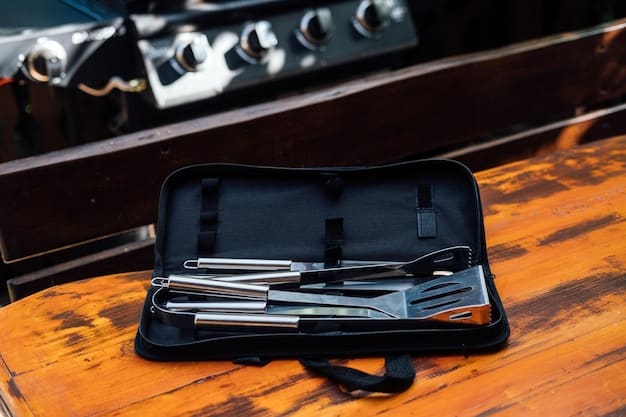 A close-up of a set of high-quality stainless steel grilling tools. The tools include tongs, spatula, and a grilling fork. The background is a blurred image of a person grilling on a sunny day.
