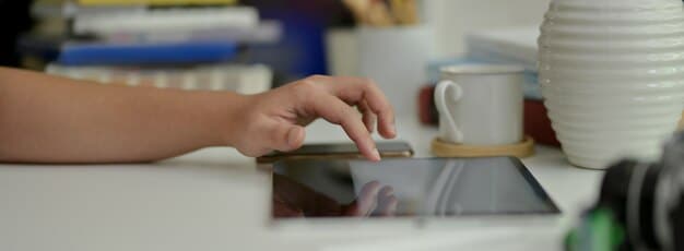A user interacting with a coffee maker's touchscreen display, highlighting the intuitive interface and ease of programming. The focus is on the user's hand and the illuminated screen, with a blurred kitchen background.