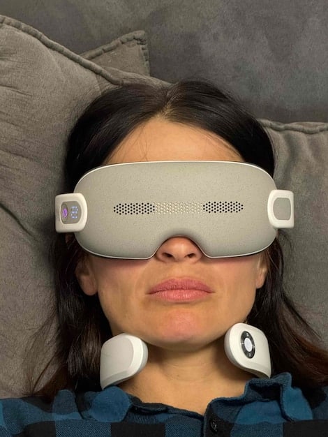 A close-up shot of sensors attached to a person's head and chest during a sleep study. The image highlights the various monitoring devices used to measure brain activity, heart rate, and breathing patterns.
