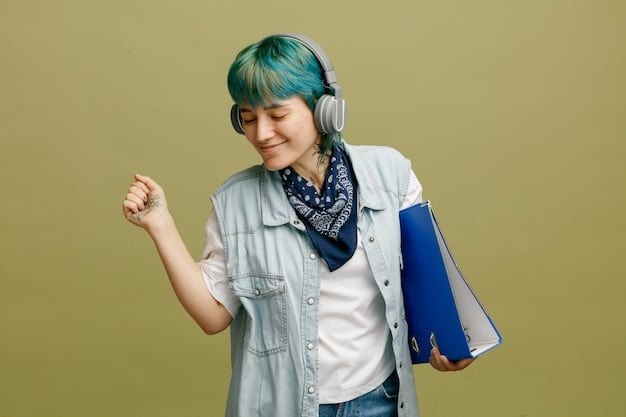 A young graduate smiling and holding their new wireless headphones, showcasing how a tech gift can bring joy and convenience.