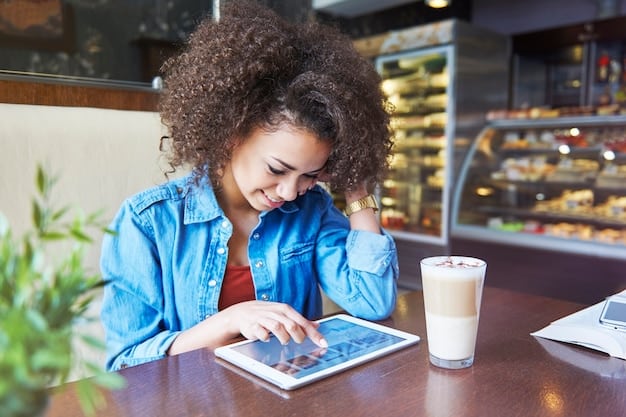 A graduate working at a coffee shop, using a portable keyboard with their tablet, emphasizing the convenience and portability beneficial for students and young professionals.