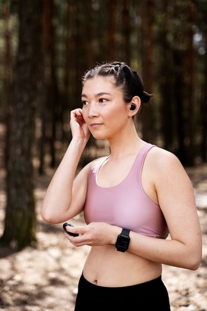 A close-up shot of a person wearing a Garmin fitness tracker while running outdoors, focusing on the watch displaying real-time data like heart rate and distance covered. The background is a blurred cityscape.