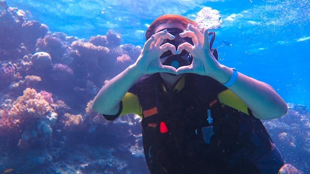 A person in a wetsuit and diving gear, giving a thumbs-up underwater next to a vibrant coral reef, with schools of colorful fish swimming around. Sunlight filters through the clear water.