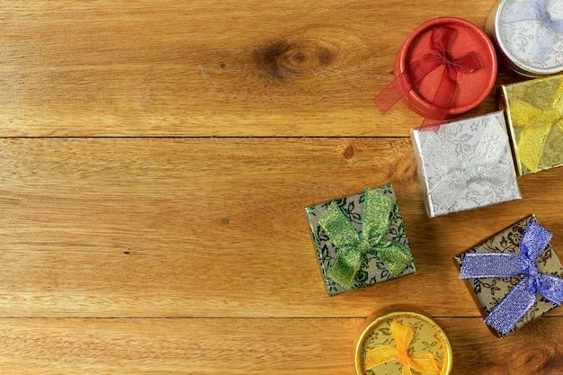 Overhead shot of various personalized photo gifts arranged on a rustic wooden table, including a custom mug with a family picture, a photo blanket draped over a chair, and a personalized calendar, all in warm, inviting tones.