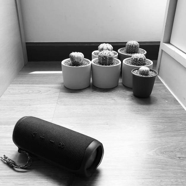 A sleek, modern Bluetooth speaker sitting on a wooden desk, playing music, with soft, ambient lighting in the background, suggesting a relaxed listening environment.