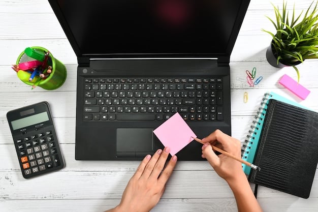 A person meticulously examining a detailed spreadsheet on a laptop, with various credit cards fanned out on the table beside them, symbolizing financial planning and careful card selection.