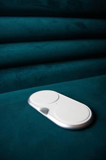 A sleek, modern wireless charging pad with a smartphone and true wireless earbuds charging simultaneously. The background is minimal and clean.
