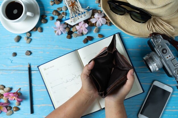 A person's hand organizing multiple credit cards in a sleek wallet, with a calendar showing future travel dates in the background, symbolizing financial planning.